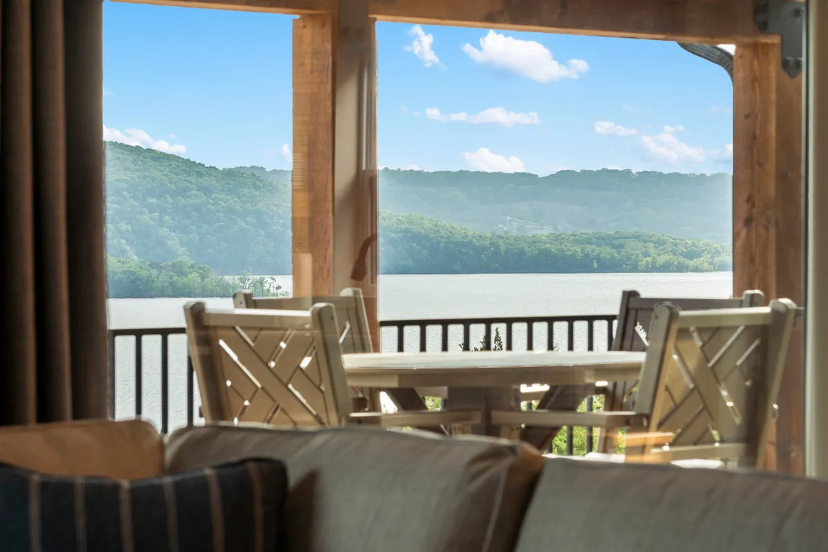 A serene outdoor dining setup with a table overlooking Table Rock Lake and the surrounding hills. The elevated view invites guests to enjoy al fresco meals, morning coffee, or sunset toasts with the lake as a stunning backdrop.